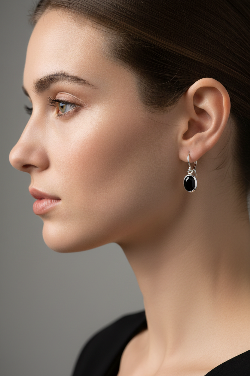 Woman wearing petite black onyx lever back earrings with clean bezel