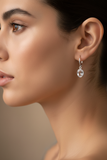 Woman wearing petite crystal quartz lever back earrings with clean bezel